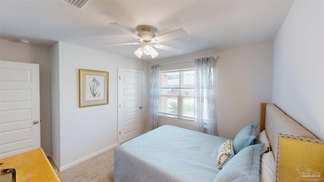 carpeted bedroom with a closet, visible vents, ceiling fan, and baseboards