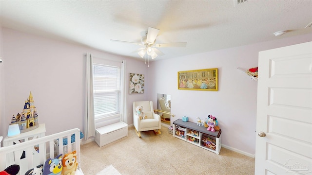 bedroom with light carpet, ceiling fan, a textured ceiling, and baseboards