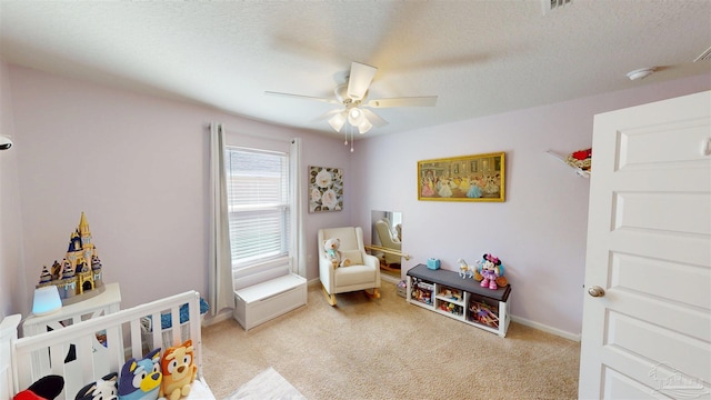 bedroom with light carpet, a ceiling fan, baseboards, and a textured ceiling