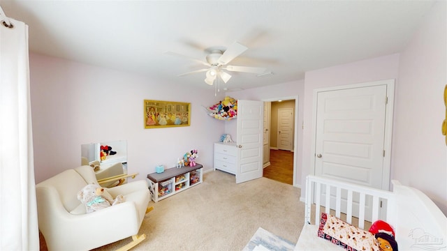 bedroom with a ceiling fan and light colored carpet