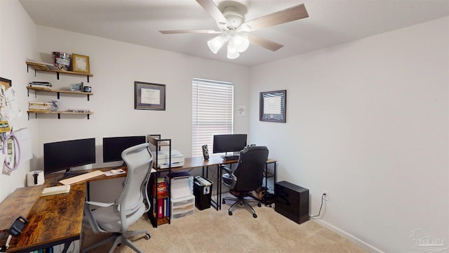 home office with a ceiling fan and light carpet