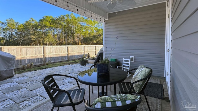 view of patio with a fenced backyard, ceiling fan, and area for grilling