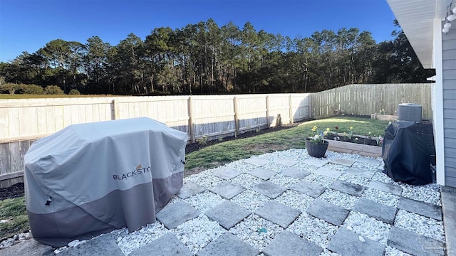 view of patio / terrace with area for grilling, a fenced backyard, and a garden