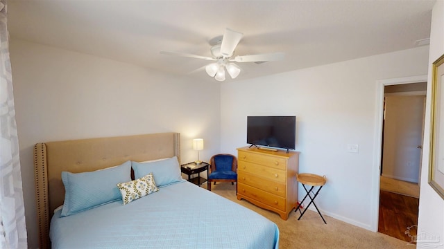 carpeted bedroom featuring baseboards and a ceiling fan