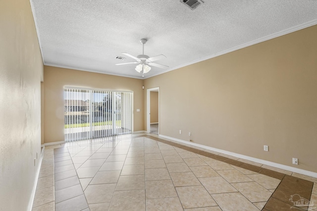 tiled spare room featuring ceiling fan, ornamental molding, and a textured ceiling