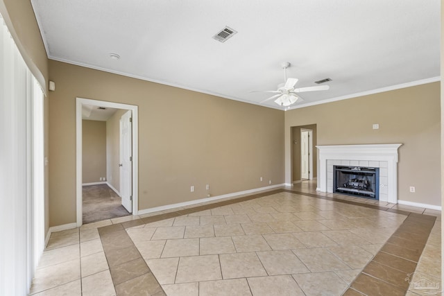 unfurnished living room with ceiling fan, a fireplace, light tile patterned floors, and ornamental molding