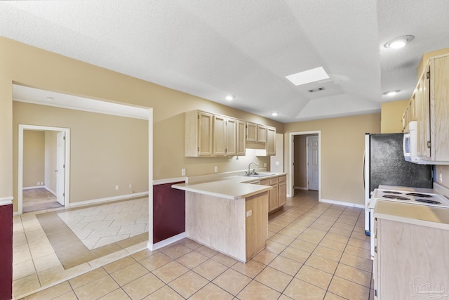 kitchen with white appliances, sink, light tile patterned floors, light brown cabinetry, and kitchen peninsula