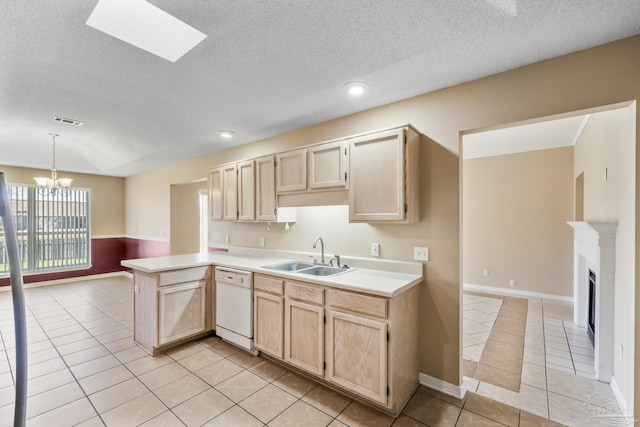 kitchen with kitchen peninsula, light brown cabinetry, white dishwasher, sink, and light tile patterned floors