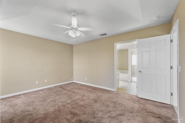 carpeted empty room featuring a textured ceiling and ceiling fan