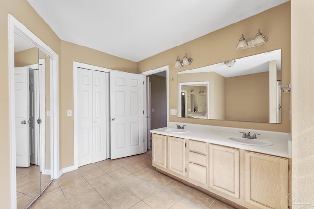 bathroom featuring tile patterned flooring and vanity