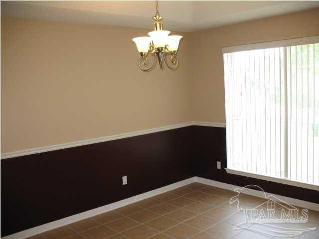 empty room featuring a notable chandelier