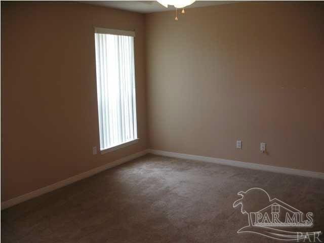 empty room featuring carpet flooring and a wealth of natural light