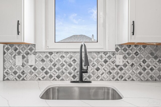 4732 Pine Ln, Pace, FL 32571 - kitchen featuring white cabinets, backsplash, and light stone countertops