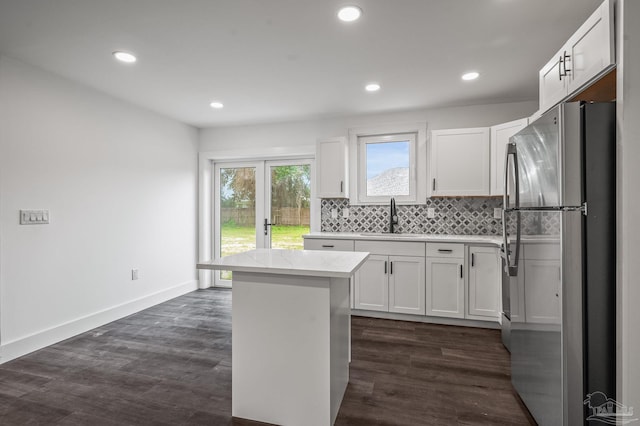 4732 Pine Ln, Pace, FL 32571 - kitchen with freestanding refrigerator, a center island, white cabinetry, backsplash, and recessed lighting
