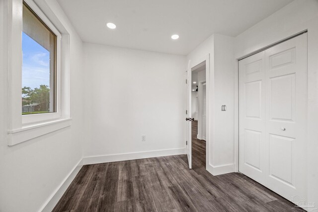 4732 Pine Ln, Pace, FL 32571 - unfurnished bedroom featuring dark wood-style flooring, recessed lighting, and a closet