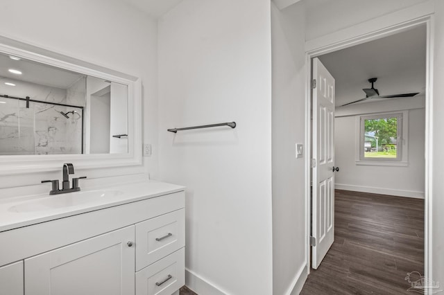 4732 Pine Ln, Pace, FL 32571 - full bath featuring a marble finish shower, vanity, ceiling fan, and wood finished floors