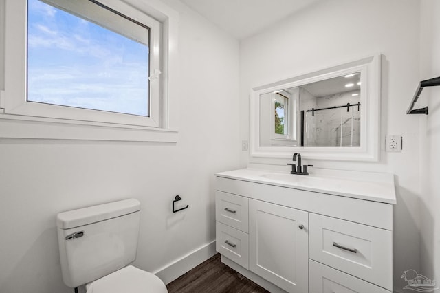 4732 Pine Ln, Pace, FL 32571 - full bathroom with vanity, a shower with door, and wood finished floors