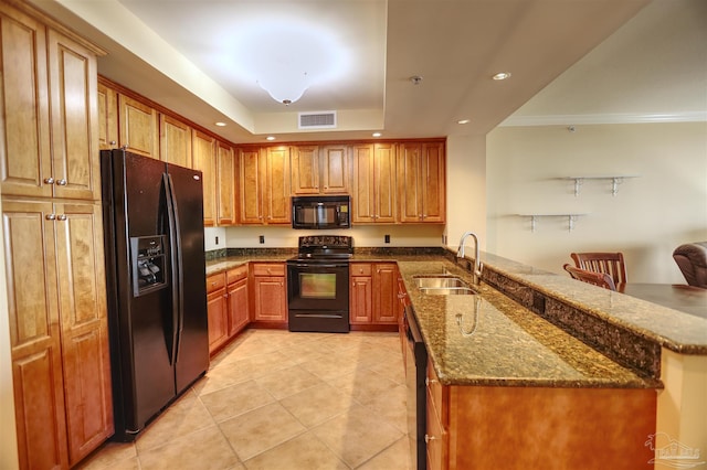 kitchen featuring black appliances, sink, ornamental molding, a kitchen bar, and kitchen peninsula