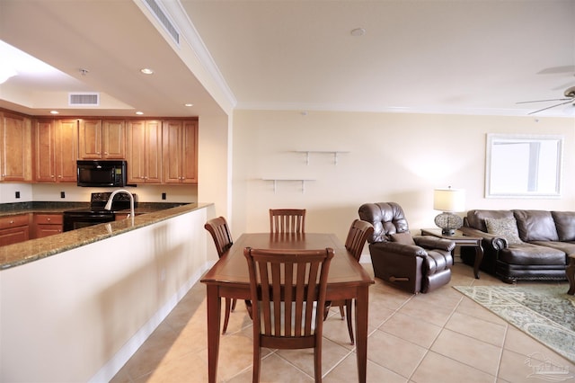 dining space with ceiling fan, light tile patterned floors, and ornamental molding