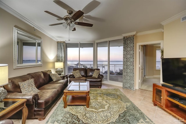 tiled living room with ceiling fan and crown molding