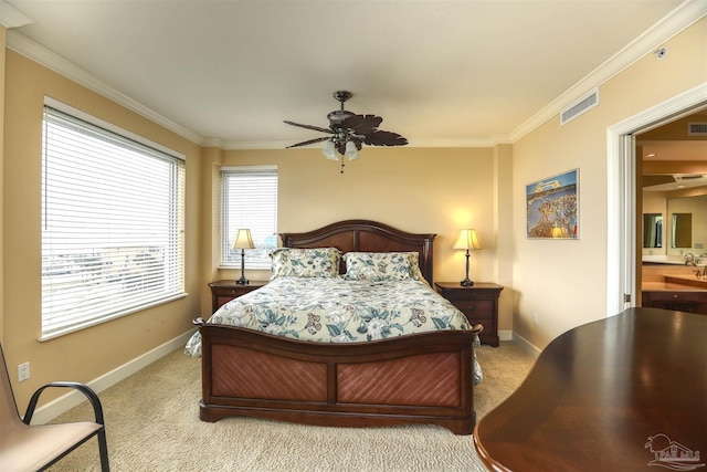 carpeted bedroom with ceiling fan and crown molding