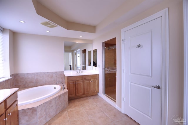 bathroom featuring tile patterned flooring, vanity, and separate shower and tub