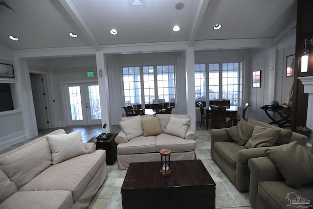 living room with beam ceiling, light tile patterned floors, and french doors