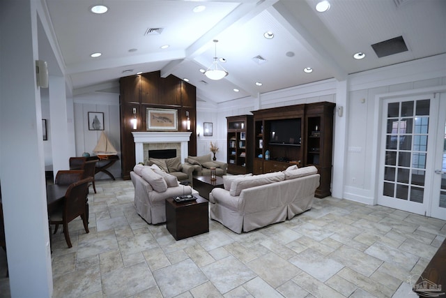 living room with vaulted ceiling with beams and a tile fireplace