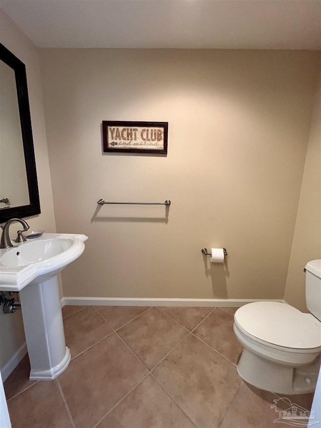 bathroom with sink, tile patterned flooring, and toilet