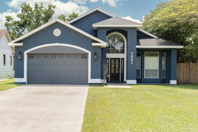 view of front of home with a front lawn and a garage