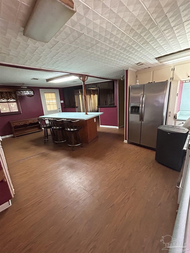 6232 Jalyn Rd, Pensacola, FL 32503 - kitchen featuring a kitchen breakfast bar, dark wood finished floors, and stainless steel fridge with ice dispenser