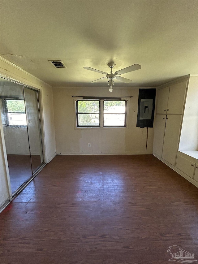 6232 Jalyn Rd, Pensacola, FL 32503 - unfurnished bedroom with dark wood-style flooring, visible vents, electric panel, and ceiling fan
