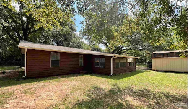 rear view of property with a lawn