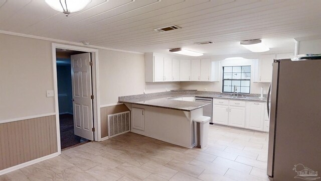 kitchen with crown molding, stainless steel appliances, sink, white cabinets, and kitchen peninsula