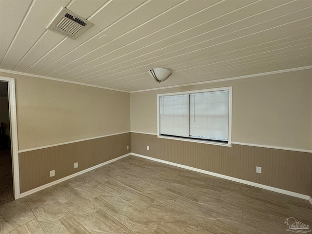 empty room with wooden walls, wooden ceiling, and ornamental molding