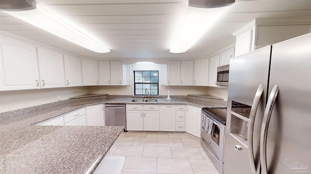 kitchen with light tile patterned floors, white cabinetry, sink, and appliances with stainless steel finishes