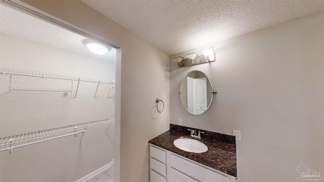 bathroom featuring vanity and a textured ceiling