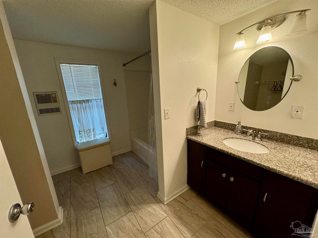 bathroom with  shower combination, vanity, and a textured ceiling