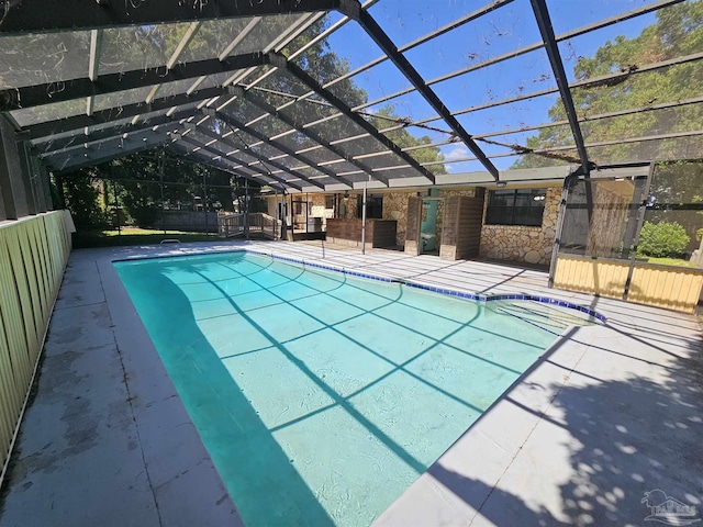 view of swimming pool with a lanai and a patio