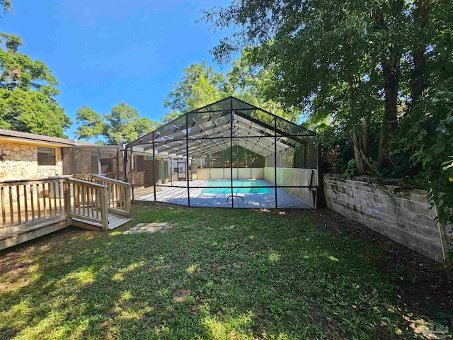 view of yard with glass enclosure, a patio area, and a fenced in pool