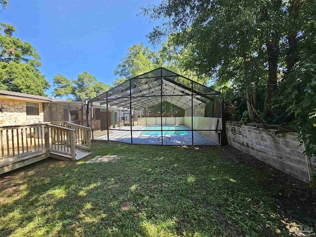 view of yard with a lanai, a patio, and a swimming pool side deck