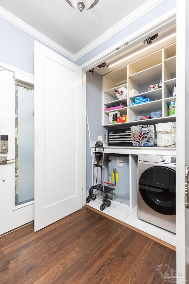 laundry area featuring crown molding, wood-type flooring, and washer / dryer