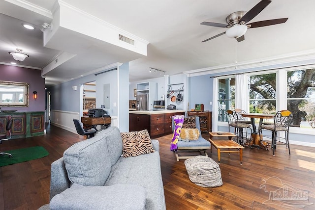 living room featuring dark hardwood / wood-style flooring, ceiling fan, and ornamental molding