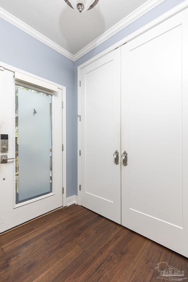 entryway featuring crown molding and dark hardwood / wood-style flooring