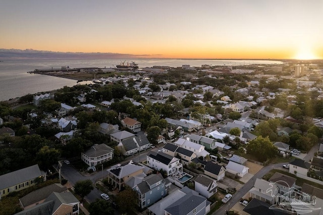 aerial view at dusk with a water view