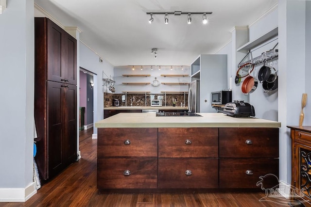 kitchen featuring dark hardwood / wood-style floors, kitchen peninsula, stainless steel fridge, black cooktop, and dark brown cabinets