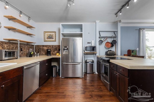 kitchen featuring dark brown cabinets, stainless steel appliances, crown molding, and dark wood-type flooring