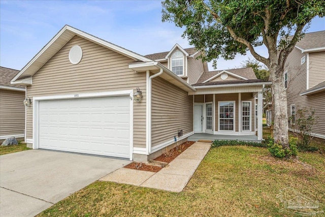 view of front of property featuring a garage, a front yard, and covered porch