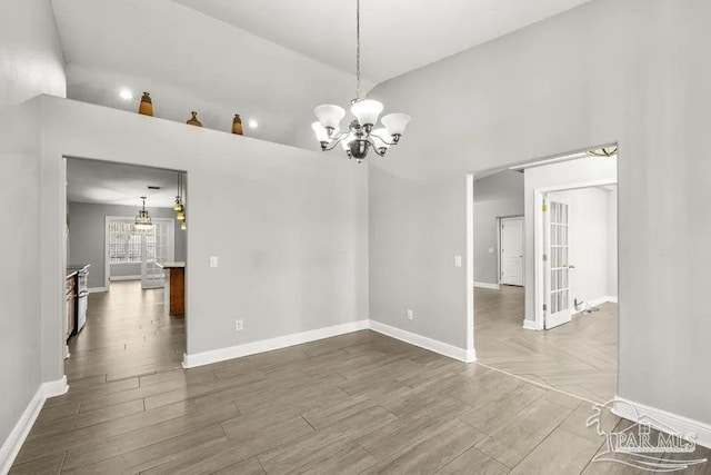 7210 Annandale Dr, Pensacola, FL 32526 - spare room featuring hardwood / wood-style floors, a notable chandelier, and a towering ceiling