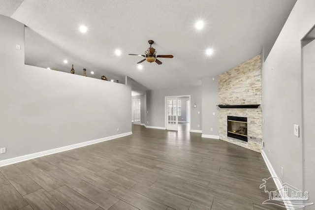 7210 Annandale Dr, Pensacola, FL 32526 - unfurnished living room with a fireplace, wood-type flooring, vaulted ceiling, and ceiling fan